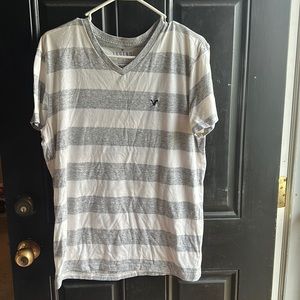 T shirt. Gray and white strips
